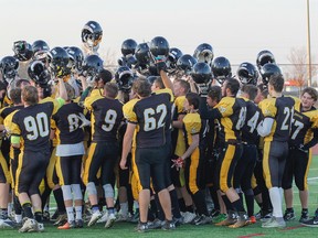 The La Salle Black Knights celebrate with a team cheer after beating the Almonte Thunderbolts 28-16 in the Eastern Ontario Secondary Schools Athletic Association championship senior football game at CaraCo Home Field, in Kingston on Friday. The Black Knights will be moving on to the National Capital Bowl in Carleton Place next Saturday. (Julia McKay/The Whig-Standard)