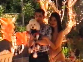 Thailand Crown Prince Maha Vajiralongkorn and his princess pose with the poodle Foo Foo, in this video from the dog's birthday party. (Handout/Postmedia Network)