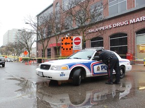 London police guard a section of Carling Street near Richmond Street Saturday to investigate after shots were fired earlier that morning. (DALE CARRUTHERS, The London Free Press)