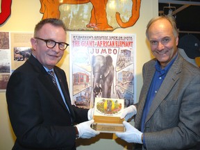 Mark O'Neill, left, Canadian Museum of History president and CEO and Mike Baker, Elgin County Museum curator, hold a rare cigar box that once housed Jumbo-brand stogies from the Honsinger cigar factory on Talbot Street in St. Thomas. The box is now on display at the Elgin County Museum.