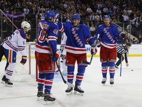 Michael Grabner (left) celebrates a goal with linemates J.T. Miller and Kevin Hayes (right) earlier this month. (Bruce Bennett, Getty Images)