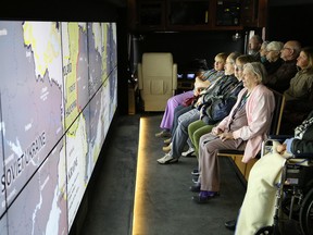 An audience watches a documentary on the Ukrainian Holodomor in the Holodomor Mobile Classroom at the Ukrainian Seniors' Centre in Sudbury, Ont. on Saturday November 19, 2016. The bus, which is part of the Holodomor National Awareness Tour, is a state-of-the-art mobile learning space designed to educate and engage students and the public about the Ukrainian Holodomor. The tour is travelling across Canada to raise awareness about the Holodomor, a genocidal famine in Ukraine, carried out in 1932Ð33 by the Soviet Union under Joseph Stalin, which resulted in the death of millions of Ukrainian men, women, and children. John Lappa/Sudbury Star/Postmedia Network