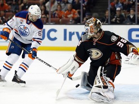 Anaheim Ducks goalie John Gibson, right, blocks a shot by Edmonton Oilers left wing Benoit Pouliot during the first period of an NHL hockey game in Anaheim, Calif., Tuesday, Nov. 15, 2016.