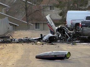 The wreckage of an American Medflight plane sits in the Barrick Gold Corp. parking lot in Elko, Nev., Saturday, Nov. 19, 2016. The Federal Aviation Administration and the National Transportation safety board will investigate the fiery crash in northern Nevada in which all four people aboard the air-ambulance flight were reported killed. (Jeffry Mullins/The Daily Free Press via AP)