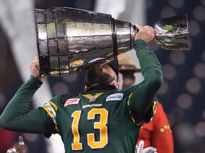 Edmonton Eskimos' quarterback Mike Reilly kisses the Grey Cup following his team's win over the Ottawa Redblacks of the 103rd Grey Cup in Winnipeg, Man. Sunday, Nov. 29, 2015.