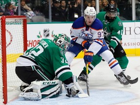 Dallas Stars goalie Kari Lehtonen (32)  blocks a shot from Edmonton Oilers center Connor McDavid (97) as Stars defender Johnny Oduya (47)  helps defend on the play in the second period of an NHL hockey game, Saturday, Nov. 19, 2016, in Dallas.
