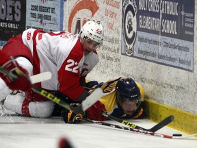 Laurentian Voyageurs' Elliott Richardson is taken to the ice by RMC defender Eric Bouchard during OUA men's hockey action at Gerry McCrory Countryside Sports Complex in Sudbury, Ont. on Saturday, Nov. 19, 2016. Ben Leeson/The Sudbury Star/Postmedia Network