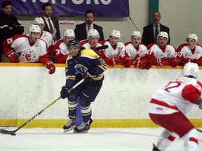 Laurentian Voyageurs' Caleb Apperson skates with the puck while eyeing RMC defender Eric Bouchard during OUA men's hockey action at Gerry McCrory Countryside Sports Complex in Sudbury, Ont. on Saturday, Nov. 19, 2016. Ben Leeson/The Sudbury Star/Postmedia Network