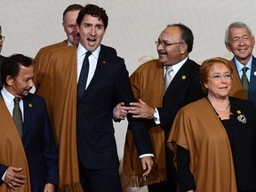 Prime Minister Justin Trudeau jokes around with fellow APEC leaders as they take part in the official family photo at the APEC Summit in Lima, Peru, on Sunday, Nov. 20, 2016. THE CANADIAN PRESS/Sean Kilpatrick