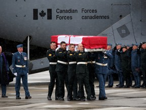 Emily Mountney-Lessard/The Intelligencer
The casket carrying the remains of Maj. Scott Foote is carried out of an aircraft towards a waiting hearse during a repatriation ceremony at CFB Trenton on Sunday.