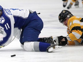 Sudbury Wolves Alan Lyszczarczyk gets tripped up by Eemeli Rasanen of the  Kingston Frontenacs during OHL action from the Sudbury Community Arena in Sudbury, Ont. on Sunday November 20, 2016. The Wolves defeated Kingston 5-3. Gino Donato/Sudbury Star/Postmedia Network