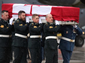 Soldiers carry the casket of Maj. Scott Foote of Kingston to a waiting hearse during a repatriation ceremony at CFB Trenton on Sunday. (Emily Mountney-Lessard/Postmedia Network)