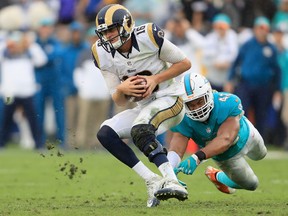 Quarterback Jared Goff of the Los Angeles Rams runs with the ball away from Spencer Paysinger of the Miami Dolphins during the third quarter of the game at Los Angeles Coliseum on Nov. 20, 2016. (Sean M. Haffey/Getty Images)