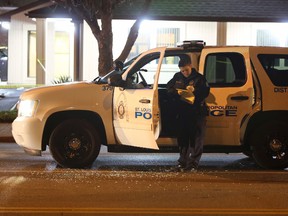 Police investigate a scene after a St. Louis police officer was shot in what the police chief called an "ambush" on Sunday, Nov. 20, 2016, in St. Louis. Police Chief Sam Dotson said the 46-year-old officer was shot in the face. The suspect got away and a massive search was underway. (David Carson/St. Louis Post-Dispatch via AP)