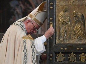 Pope Francis closes the Holy Door of St. Peter's Basilica at the Vatican, Sunday, Nov. 20, 2016, marking the end of the Jubilee of Mercy. (Tiziana Fabi/pool photo via AP)