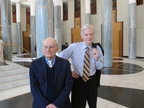 Canadian lawyers David Matas, left, and David Kilgour pose for a photograph at Australia's Parliament House in Canberra, Australia Monday, Nov. 21, 2016. The pair came to Australia's Parliament House on Monday to persuade lawmakers to pass a motion urging China to immediately end the practice of what they say is organ harvesting from prisoners of conscience. (AP Photo/Rod McGuirk)