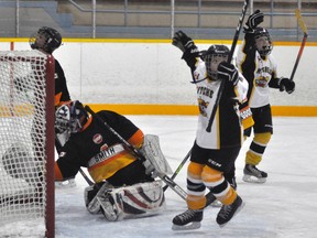 Porter Smith (left), goalie with the Central Perth Atoms, reaches back in vain to stop a shot from Noah Mann (right) of the Mitchell Atom AE’s during action from their league game Saturday, Nov. 19 at the Mitchell Arena. Also pictured is Mitchell forward Jaxen Hartwig. The Meteors won, 5-0. ANDY BADER MITCHELL ADVOCATE