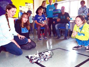 During Michelle McDonald's Grade 8 class' Robot Olympics at Mitchell District High School (MDHS) last Thursday, Nov. 17, Madalyn Smith and Olivia Burlock cheer on their robot Moopbot as it pushes Malia Glanville and Kyla Horton's robot DKML out of the ring in the sumo event. GALEN SIMMONS MITCHELL ADVOCATE