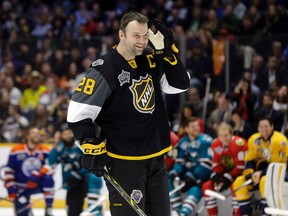 John Scott listens to the cheers as he gets ready to compete in the hardest shot competition at the NHL hockey All-Star game skills competition on Jan. 30, 2016, in Nashville. (AP Photo/Mark Humphrey)