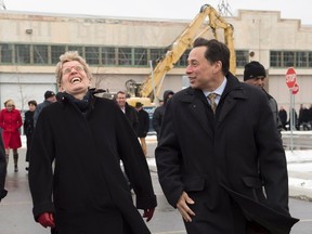 Ontario Premier Kathleen Wynne and Minister of Economic Development and Growth Brad Duguid share a laugh after a groundbreaking ceremony for the Centennial College Downsview Aerospace Campus in Toronto on Monday November 21, 2016. (THE CANADIAN PRESS/Frank Gunn)