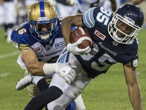 The Toronto Argonauts Diontae Spencer gets brought down by the Winnipeg Blue Bombers Taylor Loffler during CFL action in Toronto, Ont. on Friday August 12, 2016. (Craig Robertson/Postmedia Network)