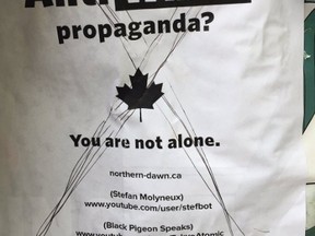 A poster splashed with the headline "Tired of anti-white propaganda, you are not alone" appeared in photos Monday on Twitter.