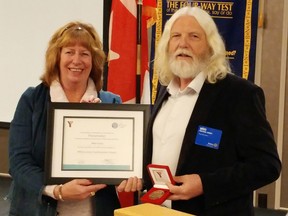 Marie Watson, assistant governor of Rotary area five, presents Mike Hurry with a YMCA Peace Medallion Monday in Sarnia. Hurry is one of three recipients this year via YMCAs across Southwestern Ontario. (Tyler Kula/Sarnia Observer/Postmedia Network)