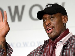 In this Oct. 25, 2013, file photo, former basketball player Dennis Rodman waves during a news conference in Tokyo. The former NBA star has been charged with hit-and-run for a wrong-way-related crash on a Southern California freeway. Orange County prosecutors filed misdemeanor charges against Rodman, Monday, Nov. 21, 2016, for a July 20, 2016, accident on Interstate 5 in Santa Ana. (AP Photo/Shizuo Kambayashi, File)