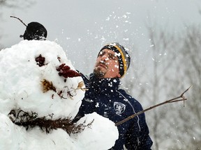 Moray Sime creates a snowman at the Tom Brown Arena in Ottawa, Ont., in this Nov. 23, 2011 file photo. (Pat McGrath/The Ottawa Citizen/Postmedia Network)