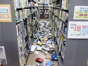 Books are scattered on the floor at a library in Iwaki, Fukushima prefecture Tuesday, Nov. 22, 2016 after a strong earthquake. A powerful earthquake off the northeast Japanese shore Tuesday sent residents fleeing to higher ground and prompted worries about the Fukushima nuclear power plant destroyed by a tsunami five year ago. (Kyodo News via AP)