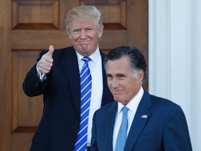 President-elect Donald Trump gives the thumbs-up as Mitt Romney leaves Trump National Golf Club Bedminster in Bedminster, N.J., Saturday, Nov. 19, 2016. (AP Photo/Carolyn Kaster)