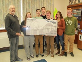 New England Arbors' John Hollingsworth gives an oversized cheque worth $1,000 to six Great Lakes Secondary School students who will be working for Shelter Canada this winter. The money will go towards paying the travel costs for the students, who will be building homes in a remote, poverty-stricken village in El Salvador. From left to right: John Hollingsworth, Tari Allen, Silas Allen, Josh Kita, Quinn Jennings, Aynsley Persad and Keaton Jennings. 
CARL HNATYSHYN/SARNIA THIS WEEK