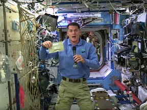 In this image taken from NASA video recorded on Friday, Nov. 18, 2016, NASA astronaut Shane Kimbrough shows a pouch of turkey he will be preparing for his crew in celebration of the Thanksgiving holiday, aboard the International Space Station. (NASA via AP)