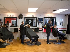 From left, Marco Bailey cuts Manvir Singh's hair, Matthew White cuts Ahmed Aljiad's hair and Kwami Lambert cuts Bart Janusz's hair at United Kutz in London, Ont. (DEREK RUTTAN, The London Free Press)