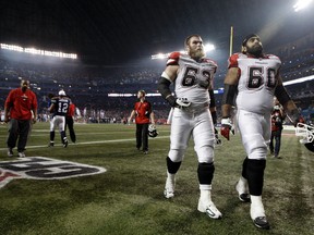 Offensive lineman Jon Gott (left) walks off the field after losing the 2012 Grey Cup with the Calgary Stampeders in Toronto. (DAVE ABEL/Toronto Sun)