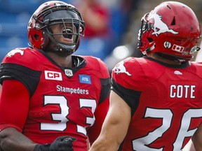 Calgary Stampeders' Jerome Messam, left, celebrates his touchdown with teammate Rob Cote during first half CFL football action against the Ottawa Redblacks in Calgary, Saturday, Sept. 17, 2016. (THE CANADIAN PRESS/Jeff McIntosh)