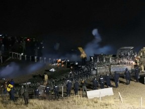 In this image provided by Morton County Sheriff’s Department, law enforcement and protesters clash near the site of the Dakota Access pipeline on Sunday, Nov. 20, 2016, in Cannon Ball, N.D. The clash came as protesters sought to push past a bridge on a state highway that had been blockaded since late October, according to the Morton County Sheriff's Office. (Morton County Sheriff’s Department via AP)