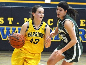 St. Michael Warriors' Taylor Caverley-Grasby drives up the court guarded by Central Rams' Vanessa Ortelli during the Huron-Perth senior girls basketball championship in 2014 at St. Michael. Caverley-Grasby is making an impact with the Cambrian College women's team this season. (SCOTT WISHART/Postmedia Network