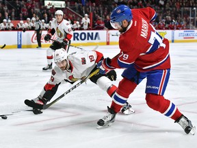 Canadiens’ Andrei Markov takes a shot as Senators’ Derick Brassard defends at the Bell Centre in Montreal last night. (Francios Lacasse/Getty Images)