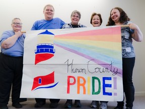 Huron County Pride committee members hold up a banner at the start of their inaugural open house on Sunday, Nov. 20. From left, Anne Clark, Greg Anderson, Tracy Taylor, Gail Huber and Laurie Gibson. (Darryl Coote/The Goderich Signal Star)