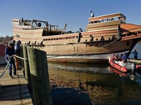 In this Nov. 18, 2016 photo, workers at Mystic Seaport move the Mayflower II from the dock into the ship-lift to be hauled out of the Mystic River at the Henry B. duPont Preservation Shipyard in Stonington, Conn. (Sean D. Elliot/The Day via AP)