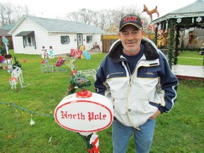 In this file photo, Gerald Ryan stands in his yard on Fairview Avenue, Froomfield, near Sarnia. His home display was the winner of the 2015  Celebration of Lights residential lighting competition. Judging for this year's competition is set for Dec. 13. (File photo/Sarnia Observer/Postmedia Network)