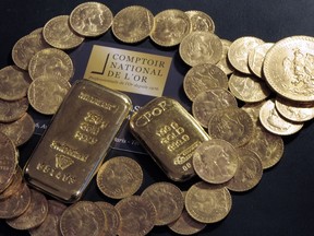 This file photo taken on October 05, 2012 shows Gold bars and coins displayed on a table at the Comptoir National de l'Or, a shop that buys, sales and estimates gold and jewellery in Paris. A Frenchman who inherited a big house from a dead relative got more than he bargained for when he discovered a glittering treasure trove of gold coins and bars worth millions stashed around the place. (BERTRAND GUAY/AFP/Getty Images)