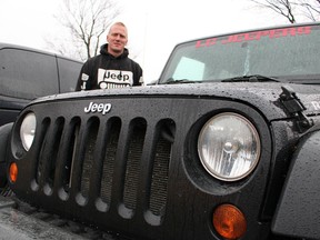 Jason Sykes, of LC Jeepers, shows off his 2007 Jeep Wrangler Rubicon in Corunna Wednesday. Members of LC Jeepers -- a club for local enthusiasts of the iconic vehicle -- will be holding a Jam a Jeep toy and food fundraiser at Sarnia's Bayview Chrysler Dodge Jeep Saturday. (Barbara Simpson/Sarnia Observer)