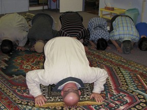 Members of the Muslim Society of Woodstock face Mecca during prayers in this photo from 2010.  The mosque is located in the basement of the Church of the Good Shepherd. (HEATHR RIVERS/WOODSTOCK SENTINEL-REVIEW)