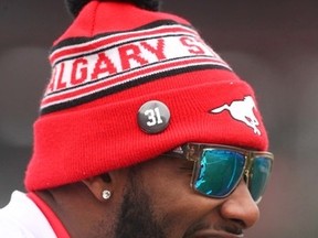 Stampeders' Odiase Osagie wears a toque and sunglasses during CFL practice in Calgary on Nov. 19, 2016. He also is wear a button in memory of Mylan Hicks. (Jim Wells//Postmedia)