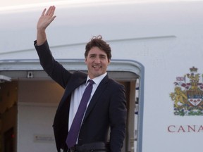 Canadian Prime Minister Justin Trudeau boards a government plane as he departs for Africa, Wednesday November 23, 2016 from Ottawa. (THE CANADIAN PRESS/Adrian Wyld)