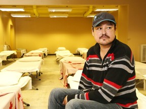 Joey Wawia, a client of the Off The Street Emergency Shelter, sits on a cot at the facility in Sudbury, Ont. on Wednesday November 23, 2016. Gino Donato/Sudbury Star/Postmedia Network