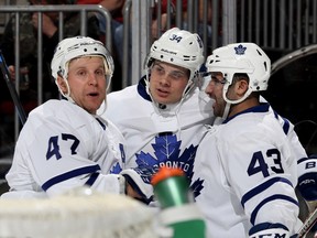 Leo Komarov #47 and Auston Matthews #34 of the Toronto Maple Leafs congratulate teammate Nazem Kadri #43 of the Toronto Maple Leafs after he scored in the first period against the New Jersey Devils on November 23, 2016 at Prudential Center in Newark, New Jersey. (Photo by Elsa/Getty Images)