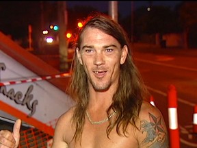 In this photo taken from video, local resident Daniel McConnell describes the scene of a car crash during a television interview Thursday, Nov. 24, 2016, in Brisbane, Australia. McConnell, dressed only in his underpants, helped police arrest the unlicensed driver who alleged crashed a car into an Australian takeout restaurant then fled. (Australian Broadcasting Corporation via the AP)